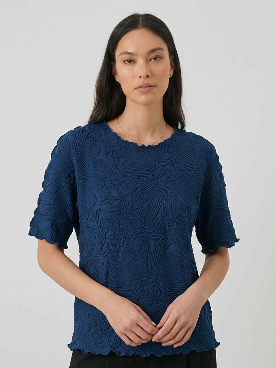 Floral jacquard pleated top with A-line silhouette, flutter sleeves, and 3D floral texture
