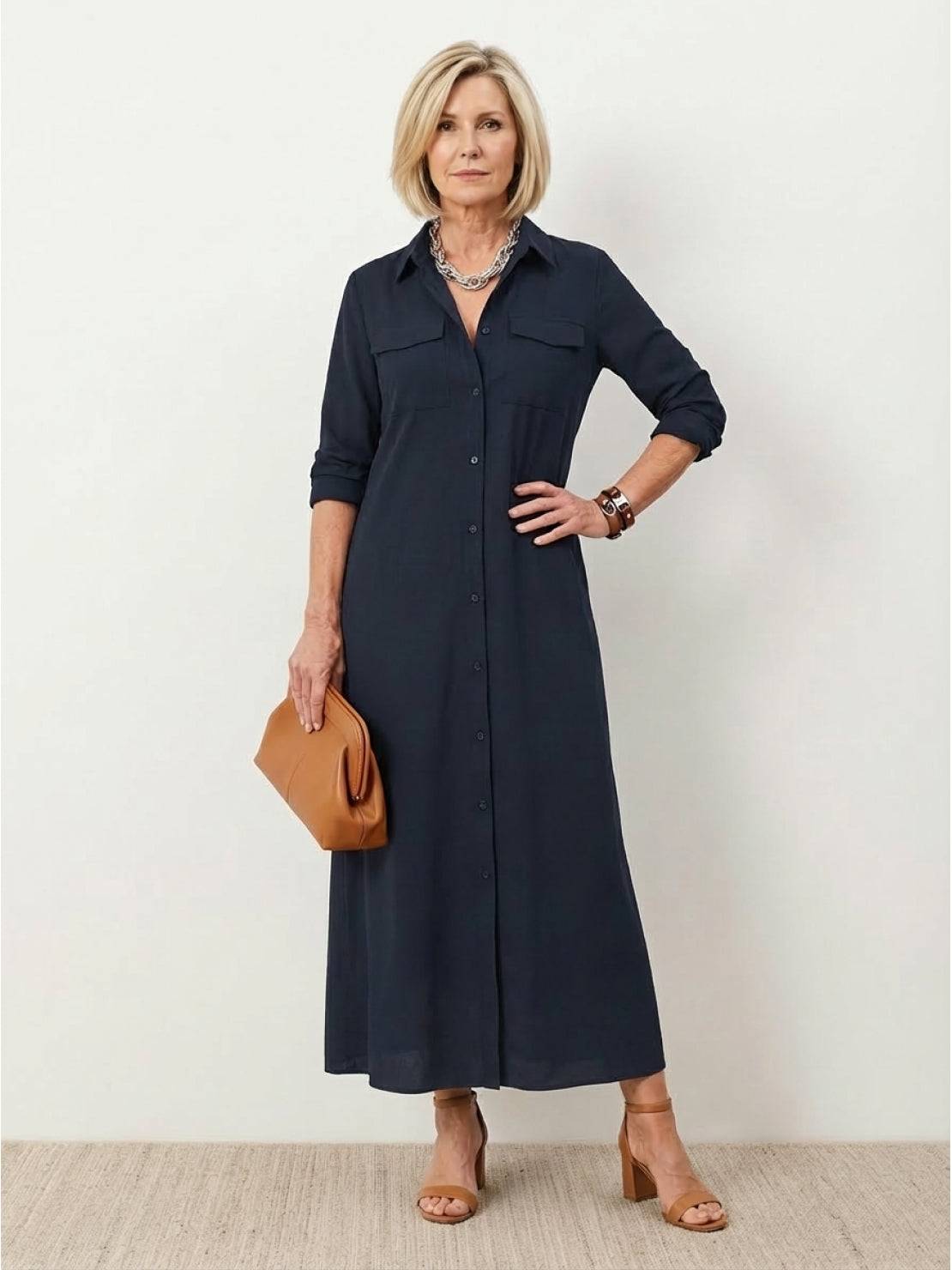 Maxi wrinkle-free button-down dress with point collar, chest pockets, long roll-up sleeves, side slits, and relaxed straight silhouette