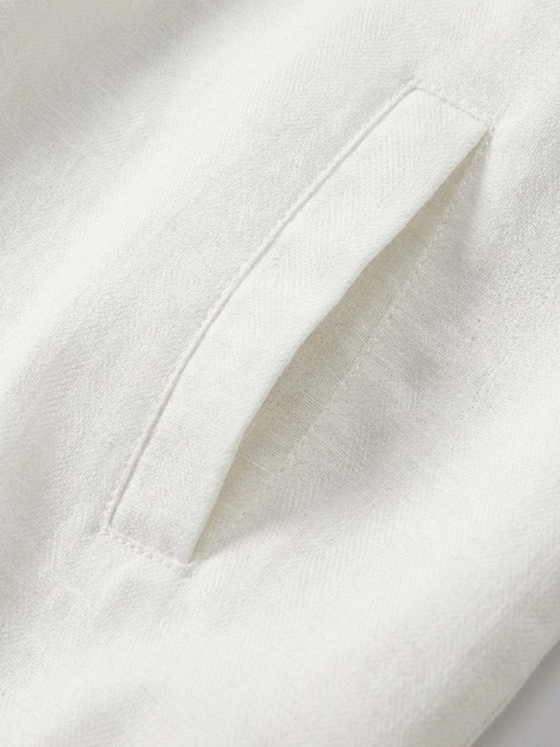 Beige linen-lyocell zip bomber jacket with ribbed waistband and buttoned chest pocket on white background