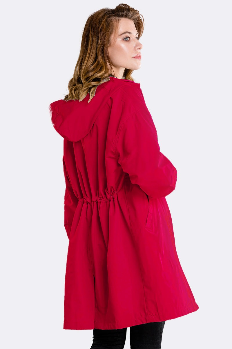 Red water resistant oversized windbreaker rain jacket with hood and adjustable waist on model back view