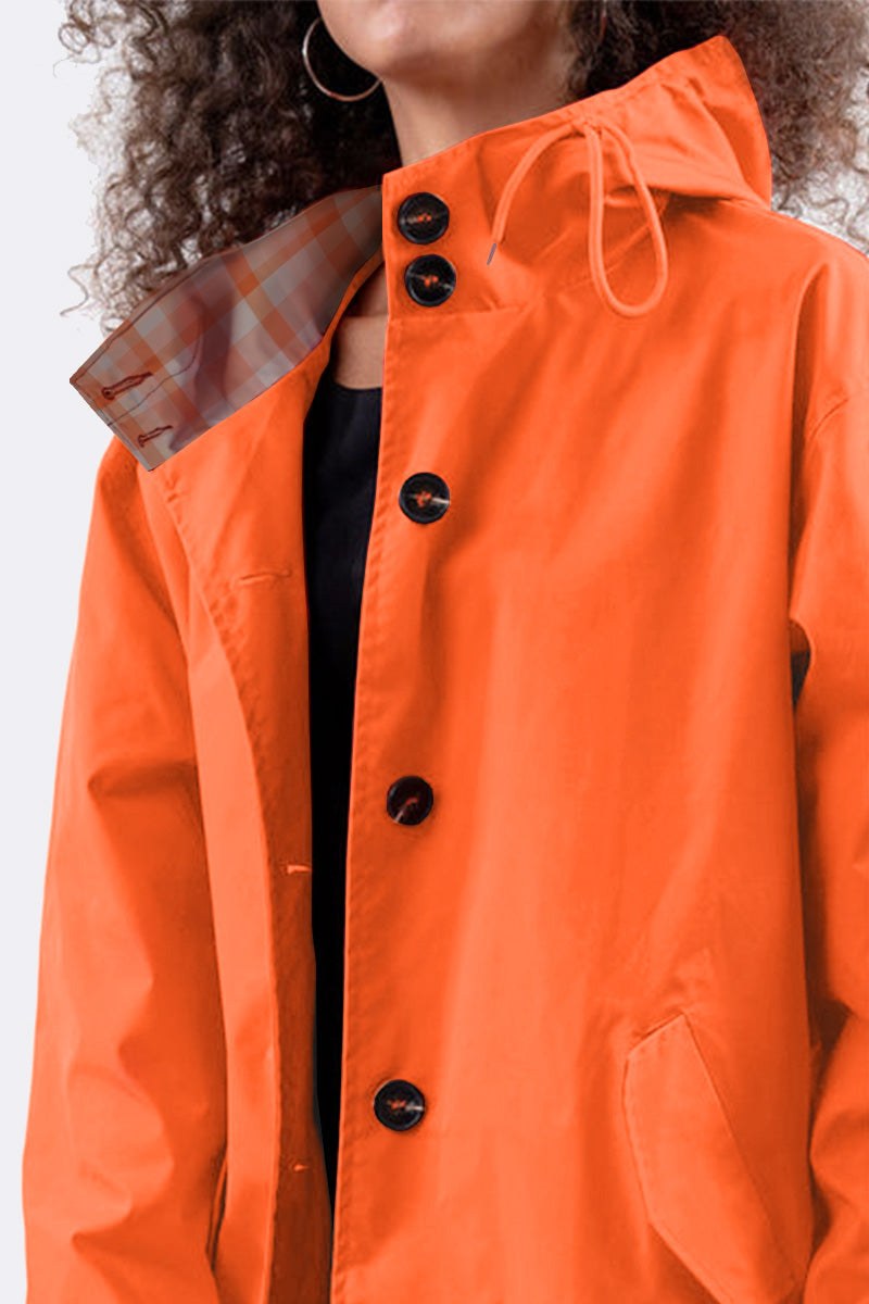 Orange water resistant oversized windbreaker jacket with hood and button closure
