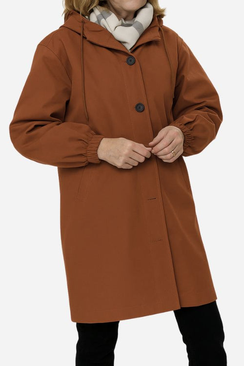Water-resistant oversized hooded windbreaker rain jacket in brown with button closure and elastic cuffs
