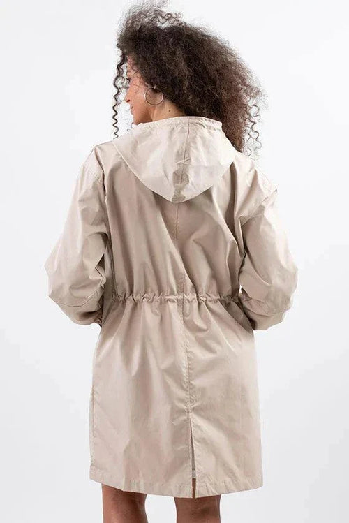 Beige water resistant oversized hooded windbreaker jacket from back view