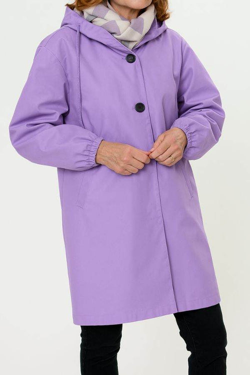 Purple water resistant oversized hooded windbreaker rain jacket on woman with scarf