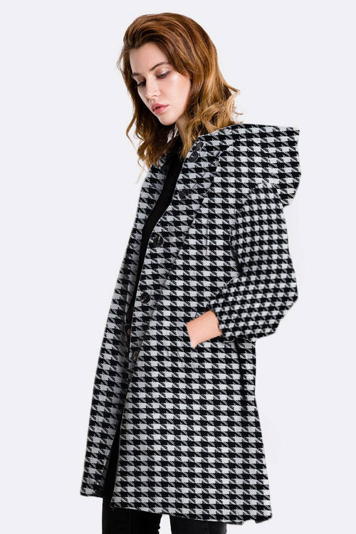 Water resistant oversized windbreaker jacket with houndstooth pattern and hood, side pockets, worn by woman