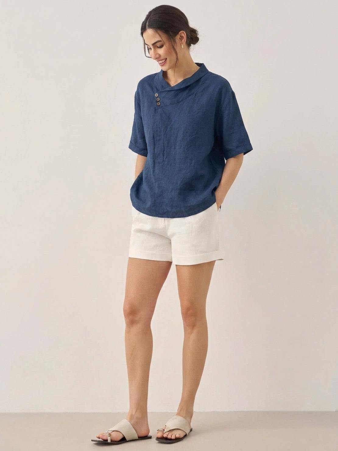 woman wearing 100% linen relaxed V-neck top with asymmetric button detail in cream color