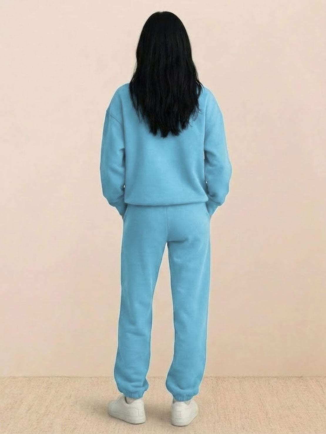 Woman wearing a comfortable cotton-blended two-piece tracksuit with high collar and deep zipper, styled for casual confidence and athleisure.