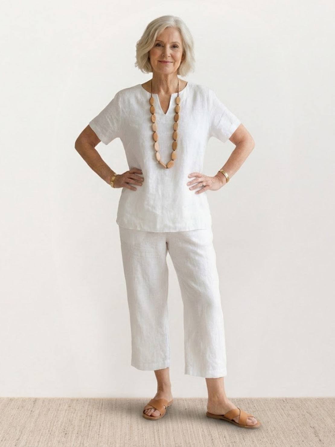 Woman wearing breezy cotton blend two-piece summer set with short-sleeved shirt and elastic waist pants