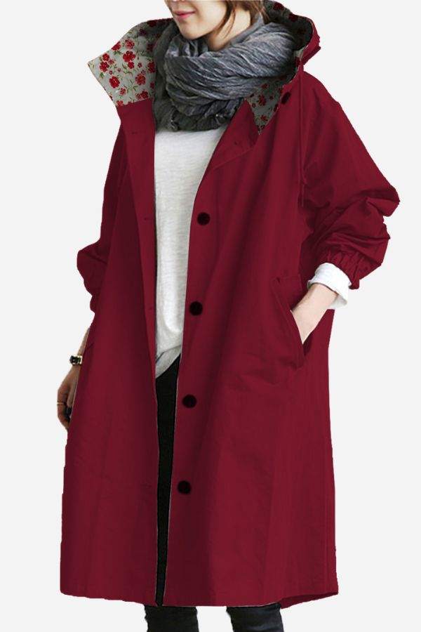 Women's oversized Rain Couture Windbreaker in burgundy, water-resistant with floral inner lining and button closure.