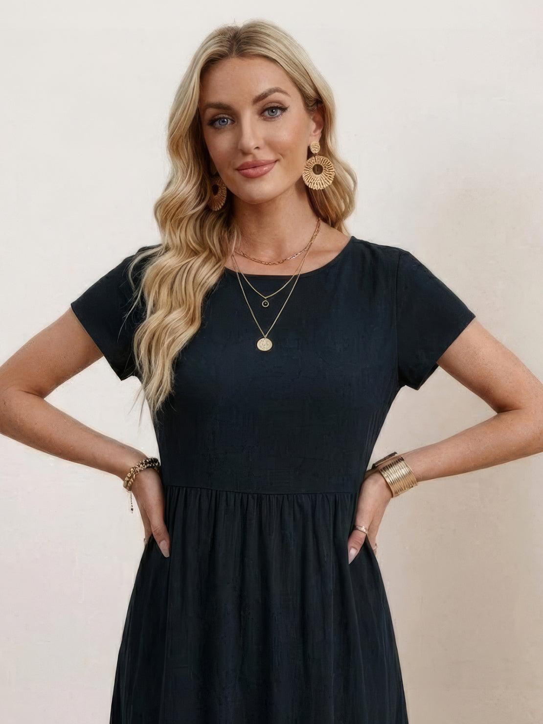 Woman wearing a capped-sleeve voluminous pleated midi dress with flowing skirt and pockets