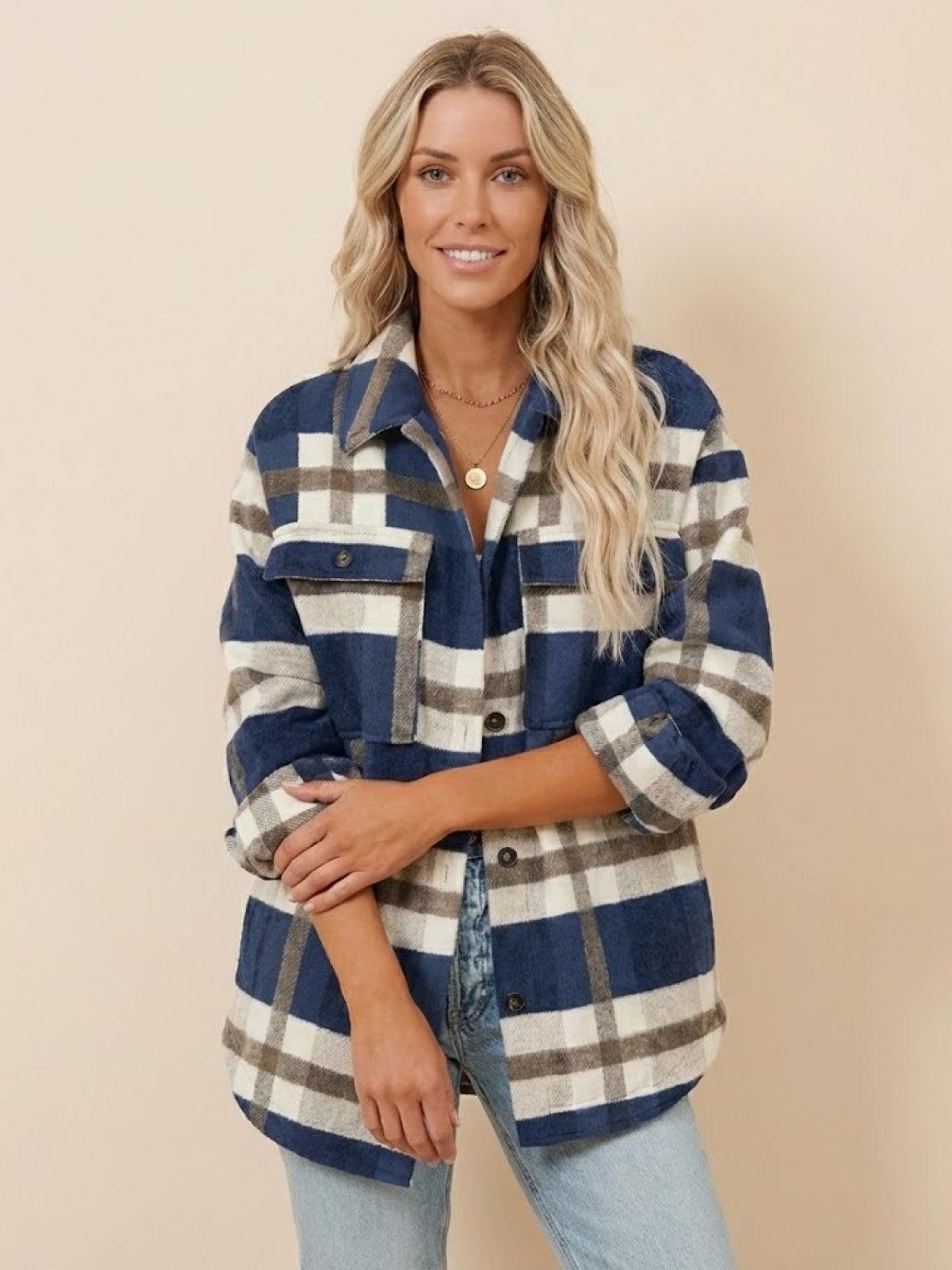 Woman wearing comfy flannel classic button-down shirt in blue and beige plaid pattern