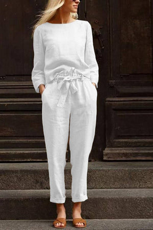 Woman wearing white relaxed longline top and wide-leg pants cotton-linen monochrome capsule outfit