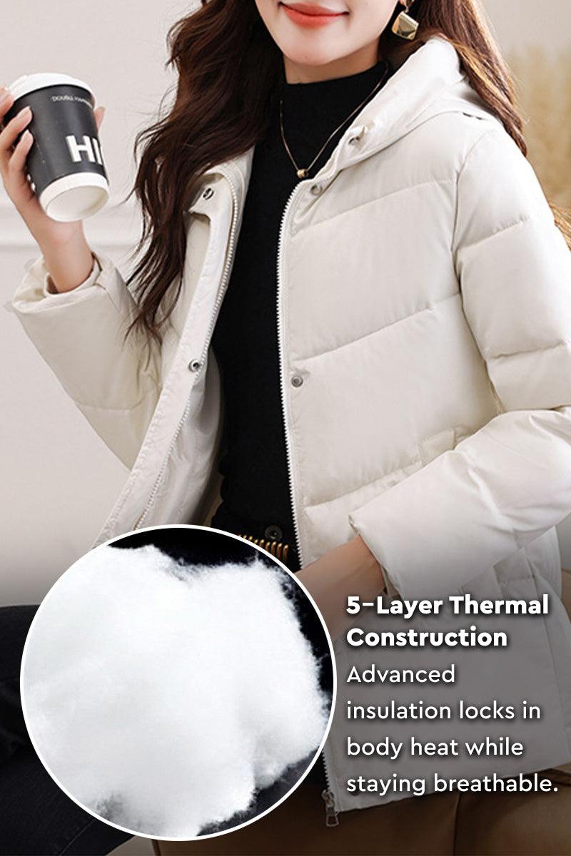 Woman wearing light beige Everyday Warmth Coat with hood and holding a coffee cup, highlighting 5-layer thermal insulation detail