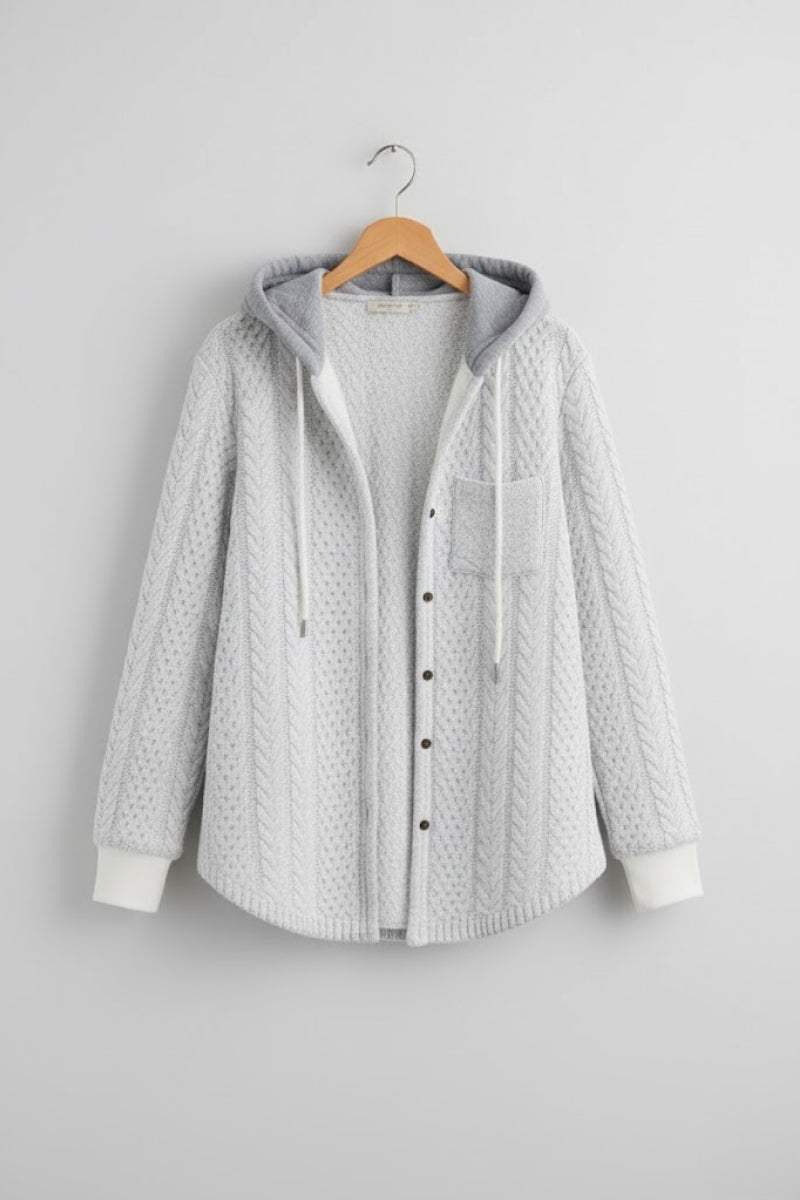 Light grey Highland Plaid Shacket with hood, button-front closure, and front pocket hanging on wooden hanger against grey wall