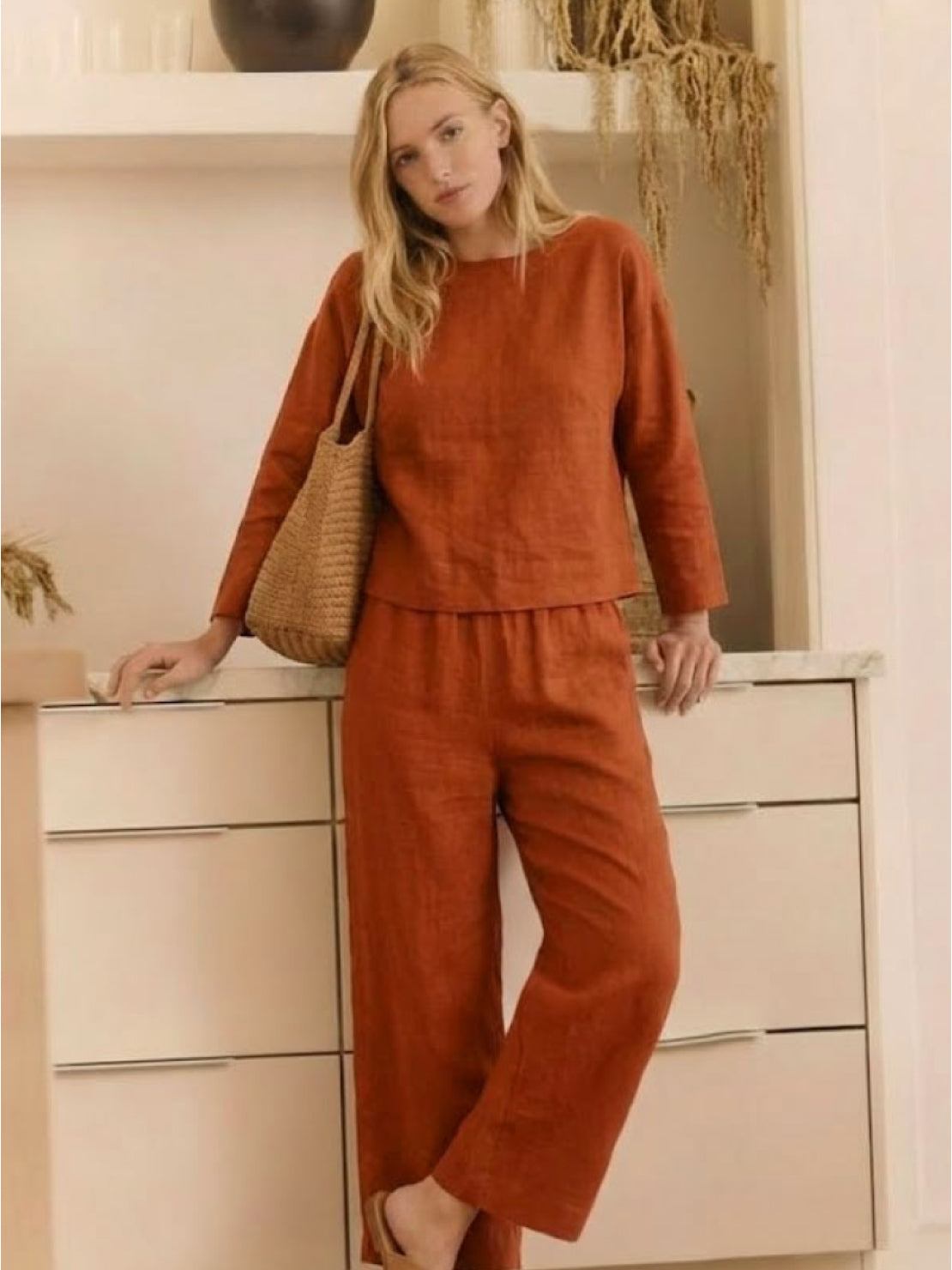 woman wearing loose solid color two-piece set with wide-leg pants and pullover top