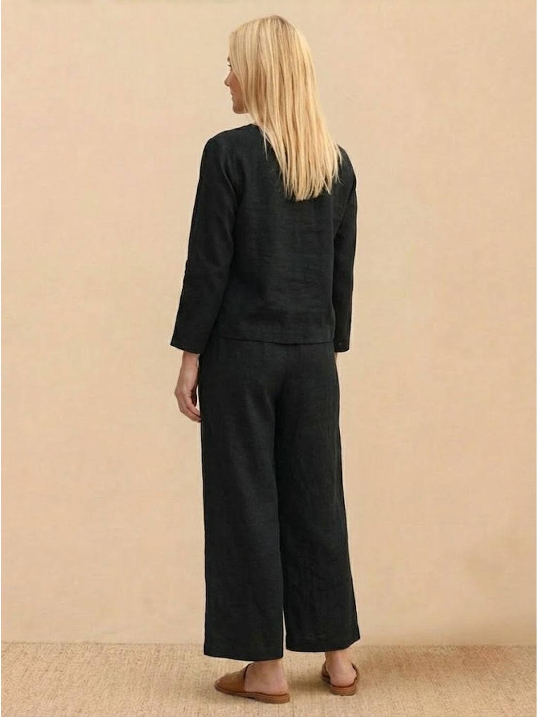Woman wearing a loose solid color two-piece set with a round-neck top and wide-leg pants in breathable fabric
