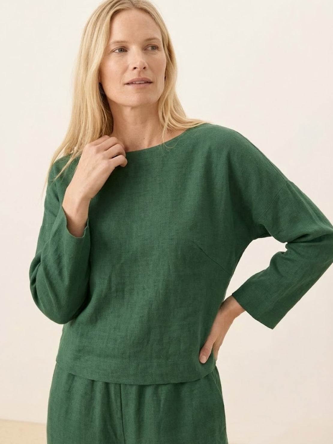 woman wearing loose solid color green two-piece set with long sleeves and relaxed fit