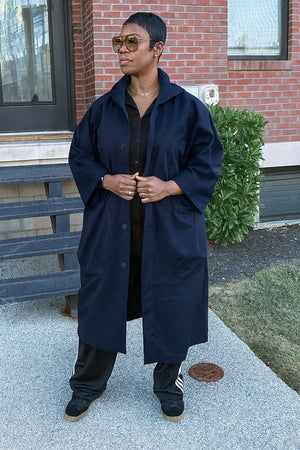 One size fits all oversized water-resistant windbreaker jacket with waterproof design and attached hood.