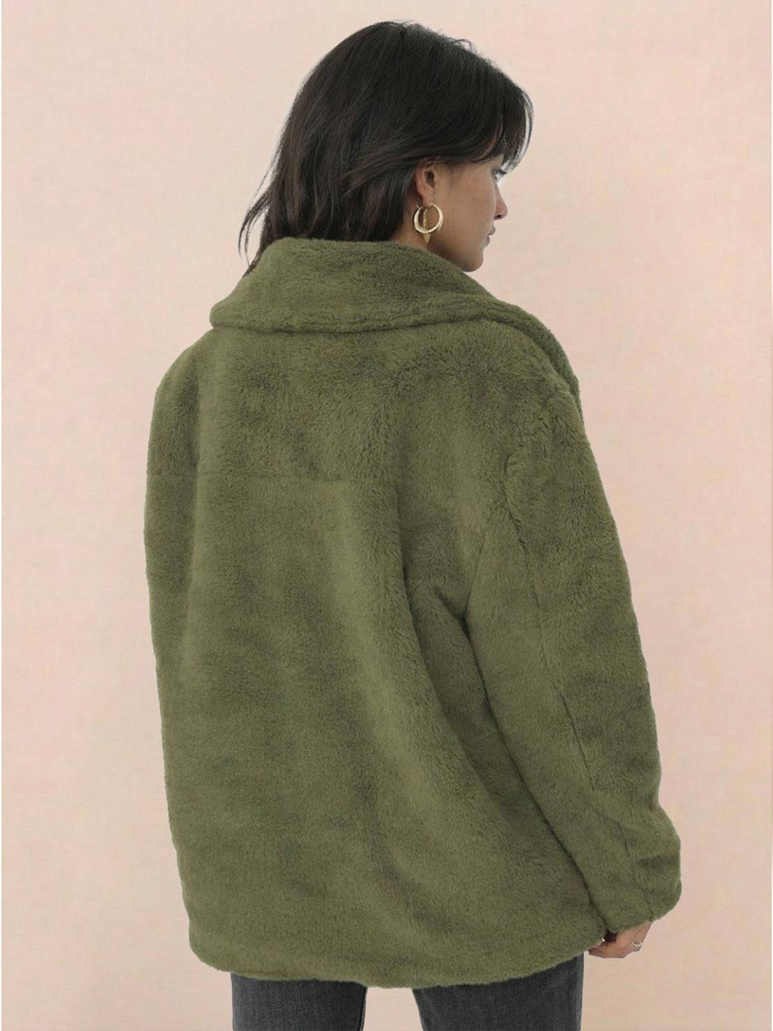 Back view of a woman wearing an olive green open front oversized faux fur jacket with a draped shawl collar and relaxed fit