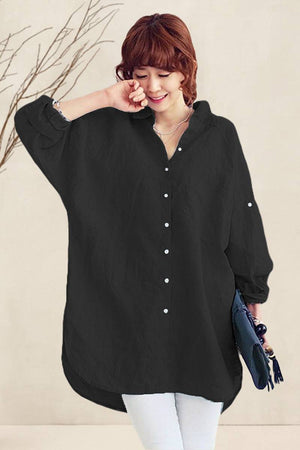 Black oversized linen shirt with relaxed fit and button detailing worn by smiling woman