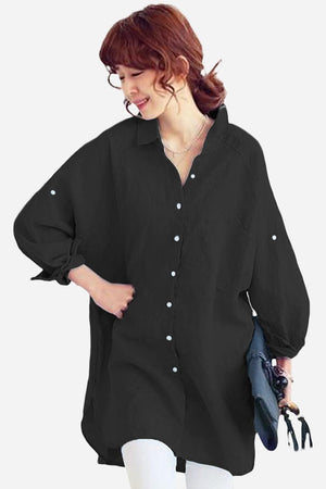 Woman wearing a black oversized linen shirt with relaxed fit and button details