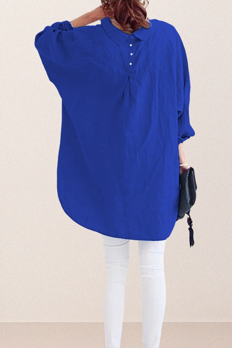 Back view of oversized linen shirt in blue with button and gathered details, paired with white pants.