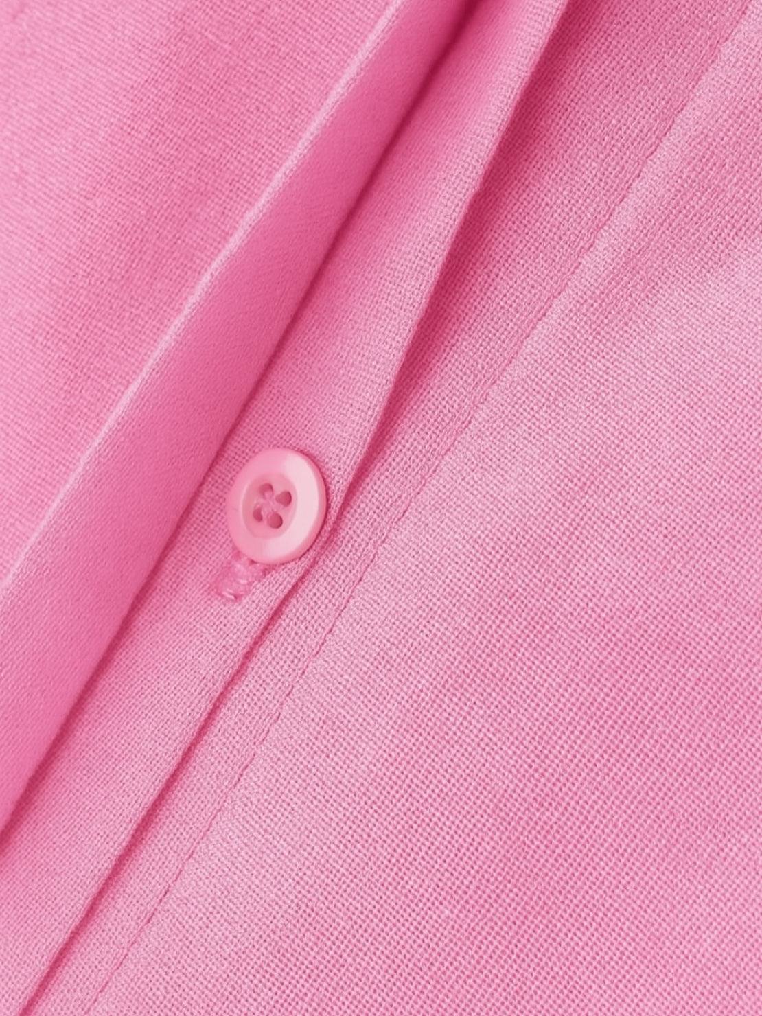 Close-up of pink oversized 100% cotton shirt fabric and button