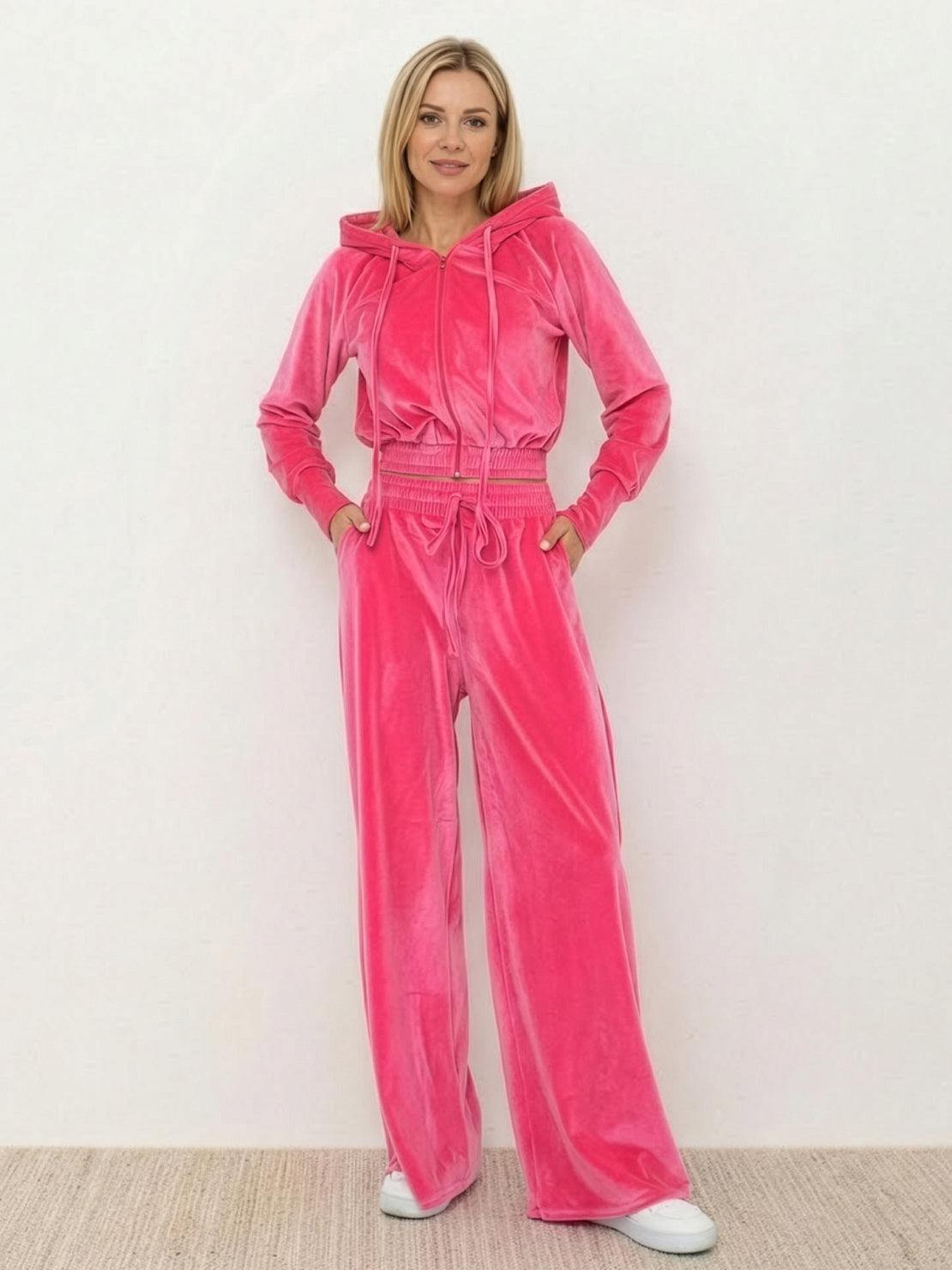 Woman wearing a modern cropped velour tracksuit with high-waist pants in vibrant color