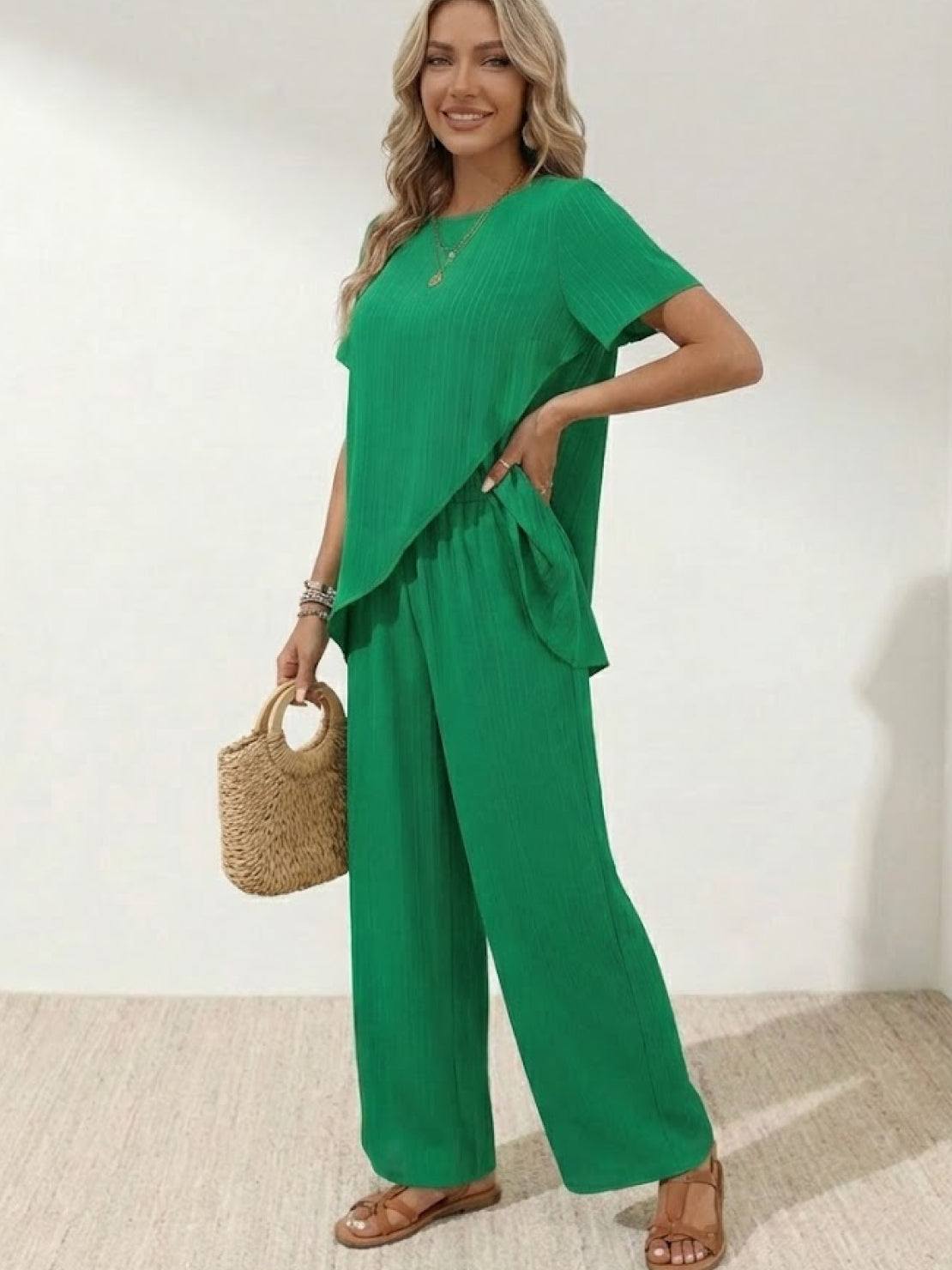Woman wearing Textured Elegance two-piece set with asymmetrical top and wide-leg pants