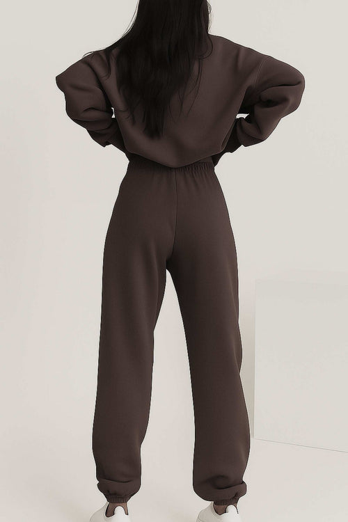 Back view of woman wearing brown cotton blend tracksuit with elastic waistband and cuffs