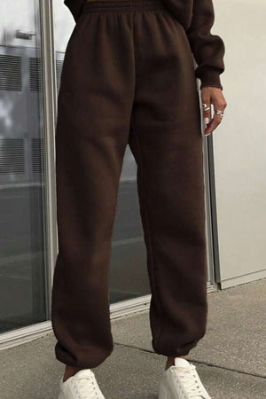 Brown cotton blend tracksuit pants with stretch waistband and cuffs paired with white sneakers, casual and comfortable athleisure wear