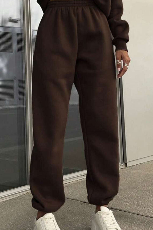 Brown cotton blend tracksuit pants with stretch waistband and cuffs paired with white sneakers, casual and comfortable athleisure wear