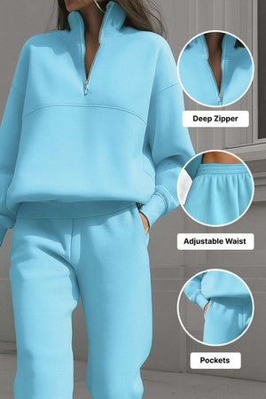 Light blue cotton blend tracksuit with deep zipper, adjustable waistband, and pockets.