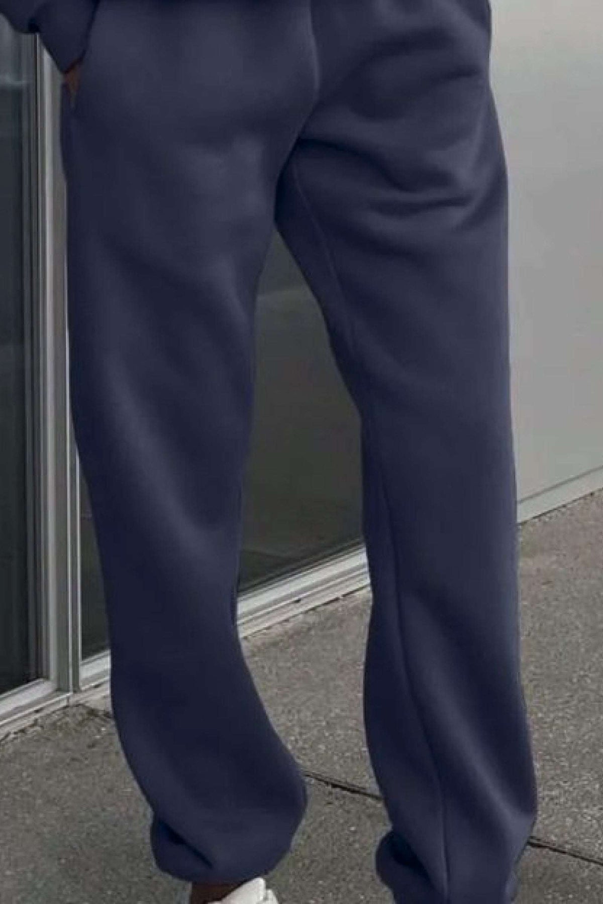 Dark navy cotton blend tracksuit pants with a relaxed fit and cuffed ankles