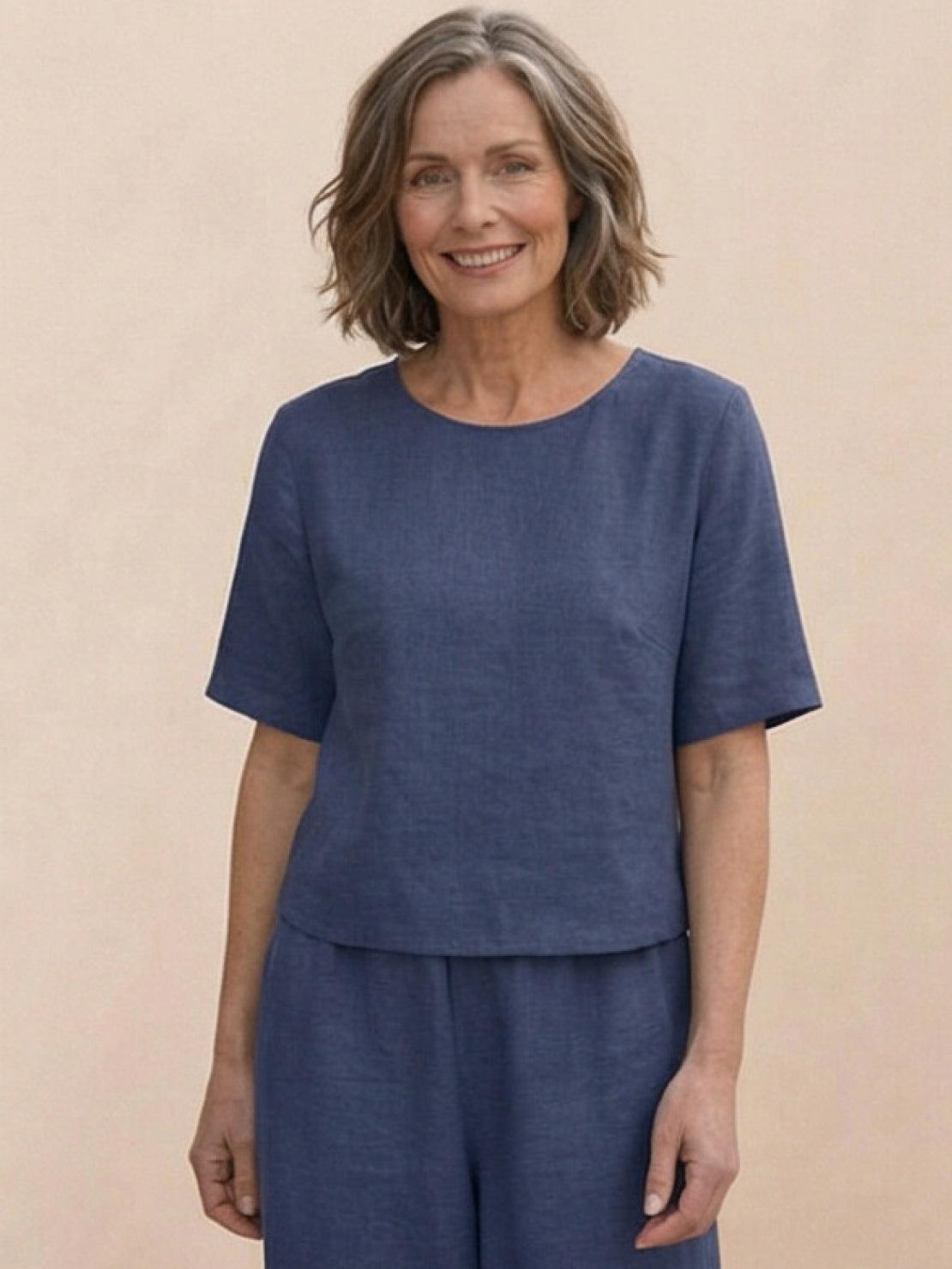 woman wearing a loose fit co-ord set with soft-tailored top and wide-leg bottoms in solid color