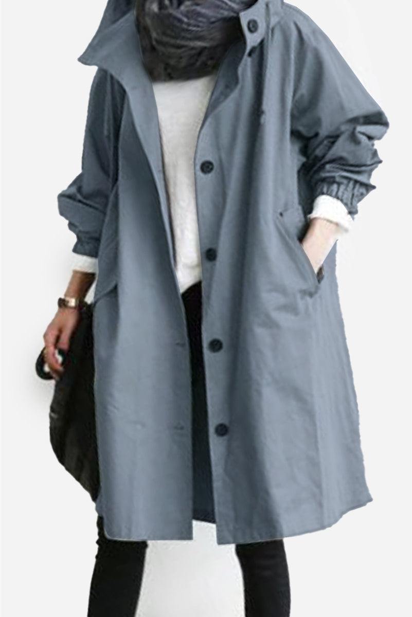 Trendy oversized Rain Couture Windbreaker in blue, lightweight and water-resistant jacket with adjustable hood and multiple pockets.