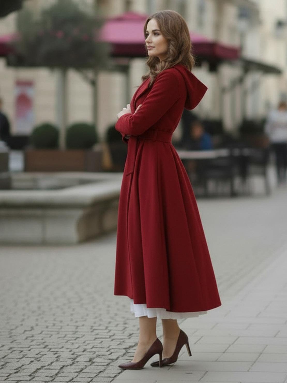 Woman wearing water-repellent rain A-line hooded raincoat with belt