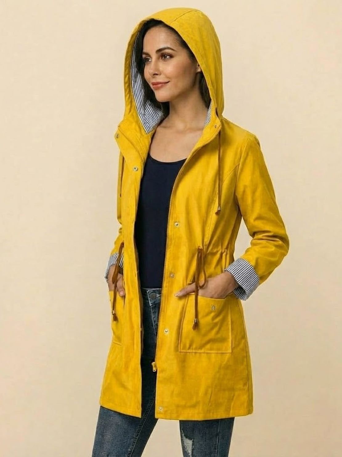 Yellow hooded water resistant windbreaker jacket with striped lining and adjustable waist for women