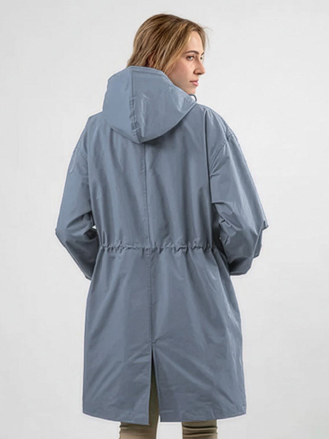 Water-resistant oversized hooded windbreaker rain jacket on display outdoors