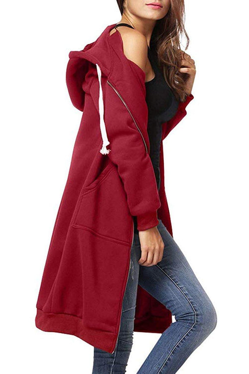 Woman wearing oversized long zip sweatshirt hoodie in red with hood and front pockets