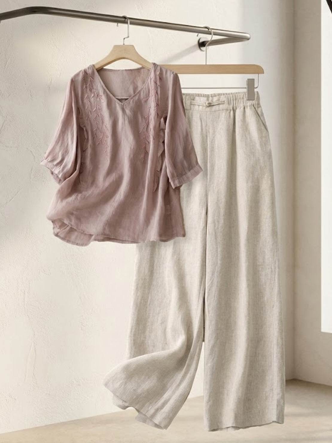 Elegant 100% cotton linen blend set with embroidered V-neck top and high-waisted wide-leg trousers.