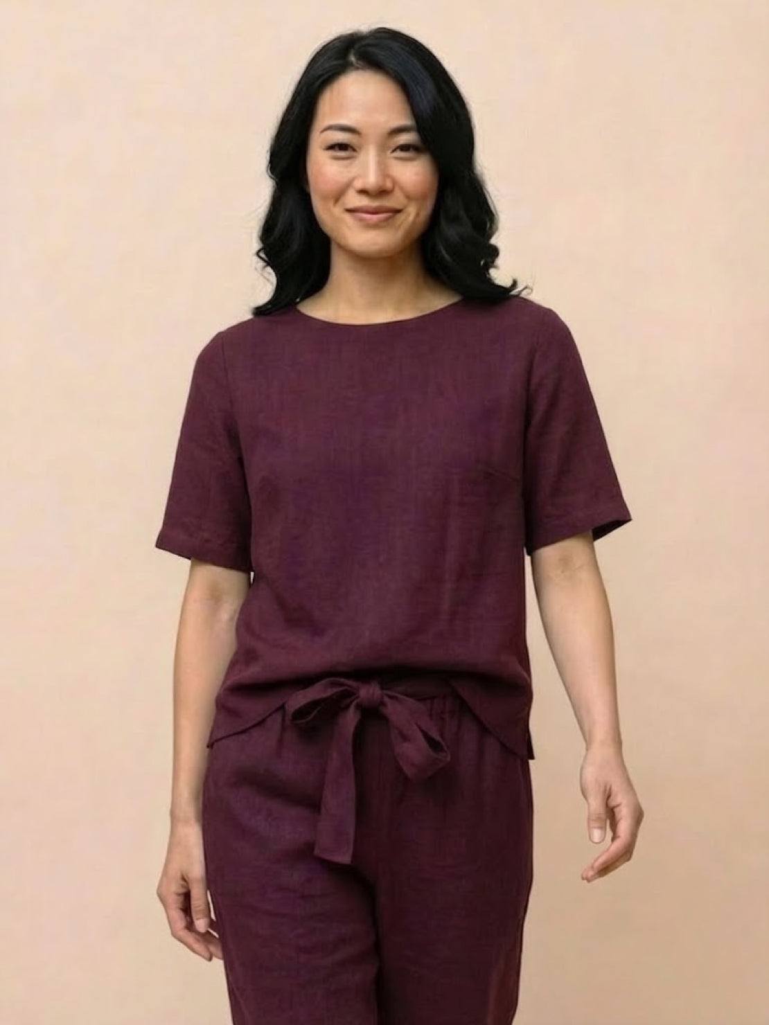 Woman wearing a breathable 100% cotton linen monochrome two-piece set with relaxed short-sleeve top and straight-leg pants
