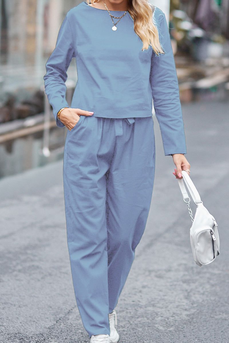 woman wearing 100 cotton linen monochrome blue two-piece set walking with white handbag