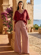 Woman wearing a striped wide-leg co-ord set with oversized top and palazzo pants