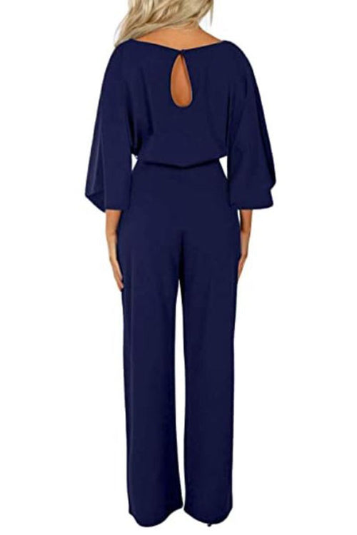 Navy blue casual long sleeve belted jumpsuit with back keyhole and batwing sleeves.