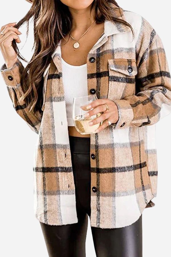 Woman wearing a brown and white long sleeve plaid flannel shirt with button closure and chest pocket, paired with black pants and white top.