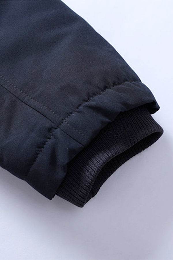 Close-up of sleeve cuff on thick long-sleeve zipper overcoat showing durable fabric and elastic ribbing detail