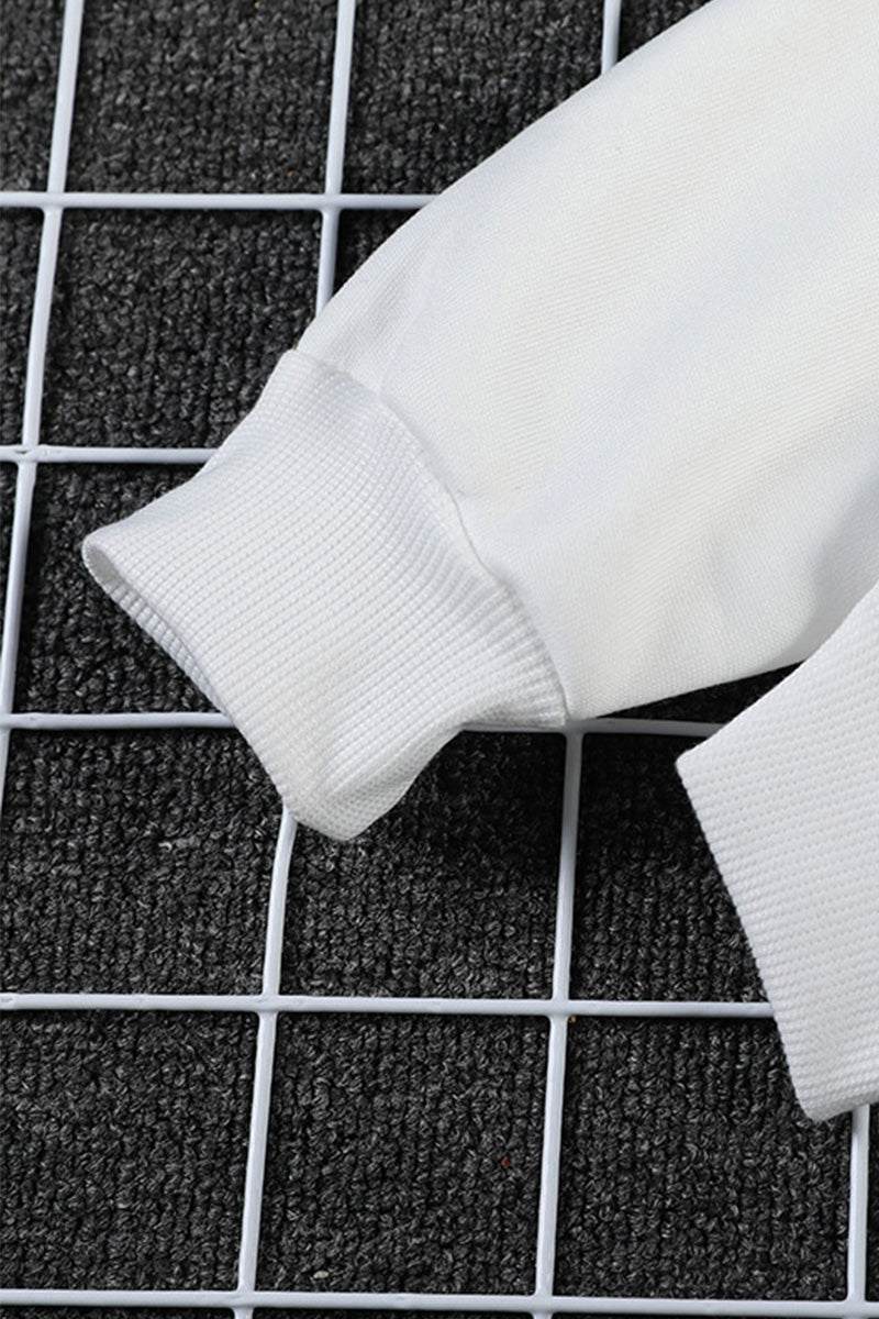 Close-up of white ribbed cuff on oversized graffiti rose hoodie sleeve on black grid background