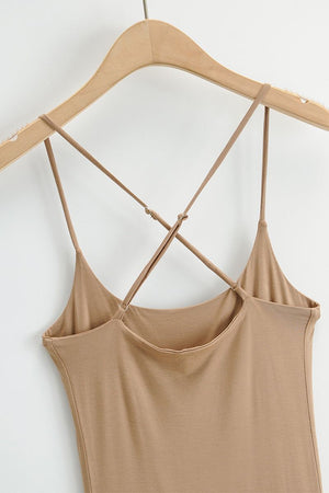 Beige elegant side slit midi dress with crisscross suspender straps on wooden hanger