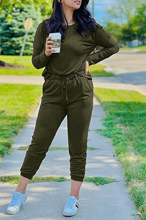 woman wearing olive green Cozy Chic Two-Piece Sweatsuit set with long sleeves and jogger pants holding coffee cup outdoors